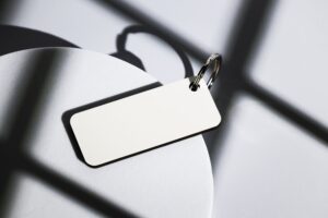 Elegant keychain on abstract shadows cast by natural light, close-up shot.